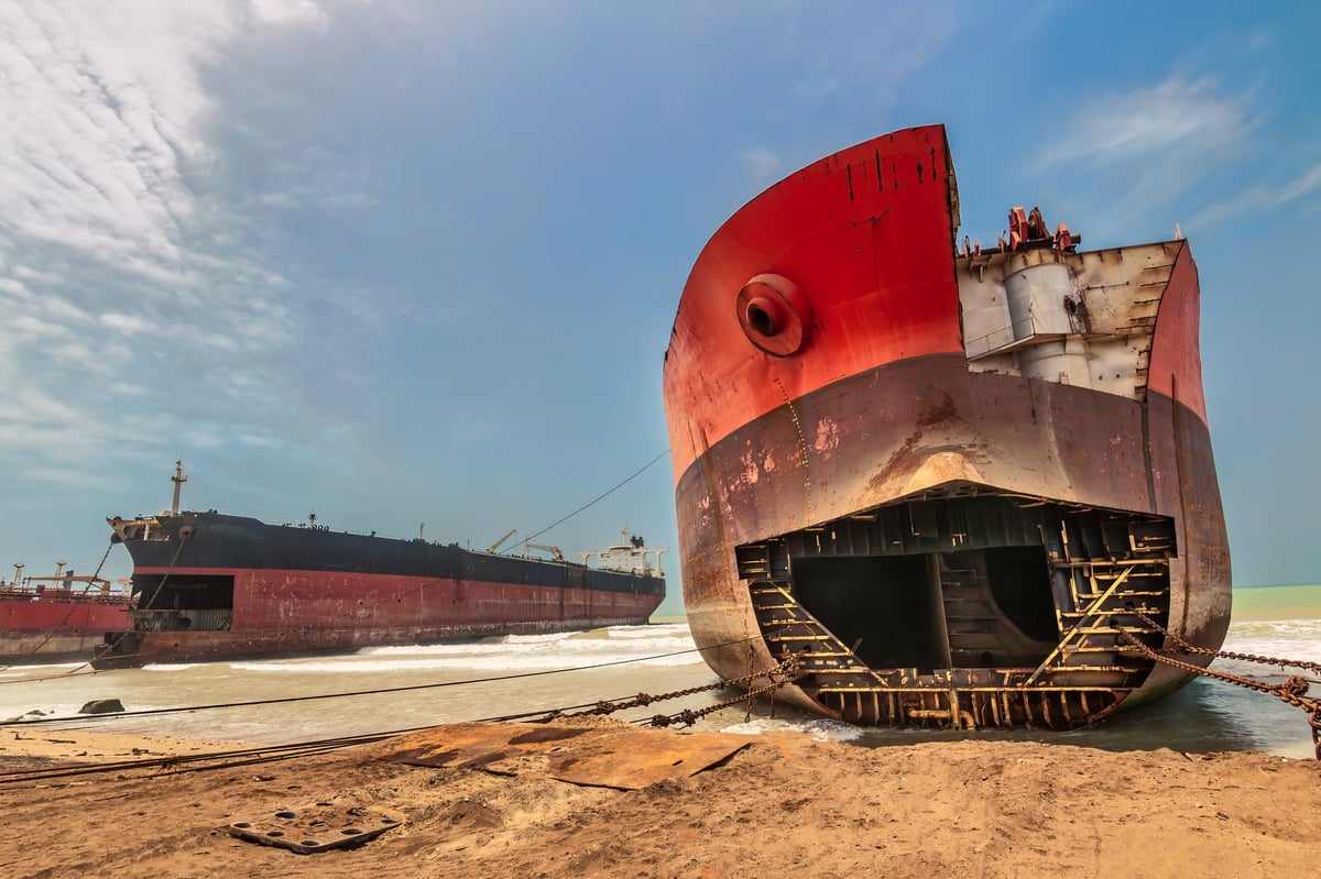 Ship breaking yard with large vessels awaiting dismantling