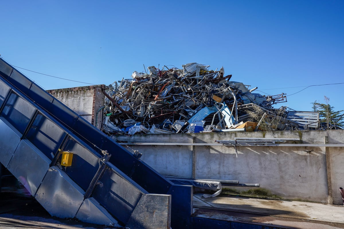 Heap of mixed iron, steel and automotive scrap at a metal recycling facility